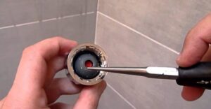 how to remove restrictor from Delta rain shower head